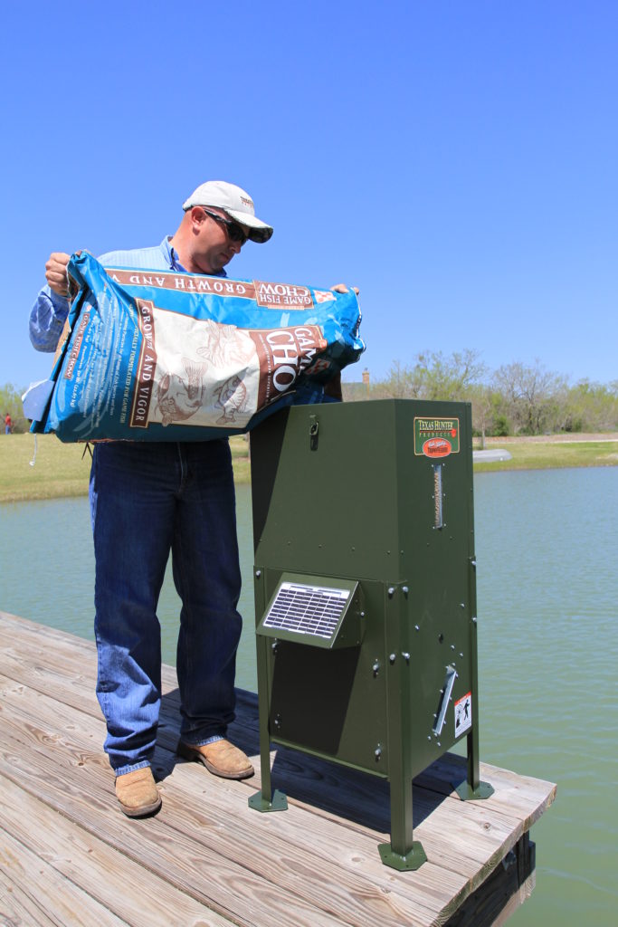 Filling a fish feeder on a private lake